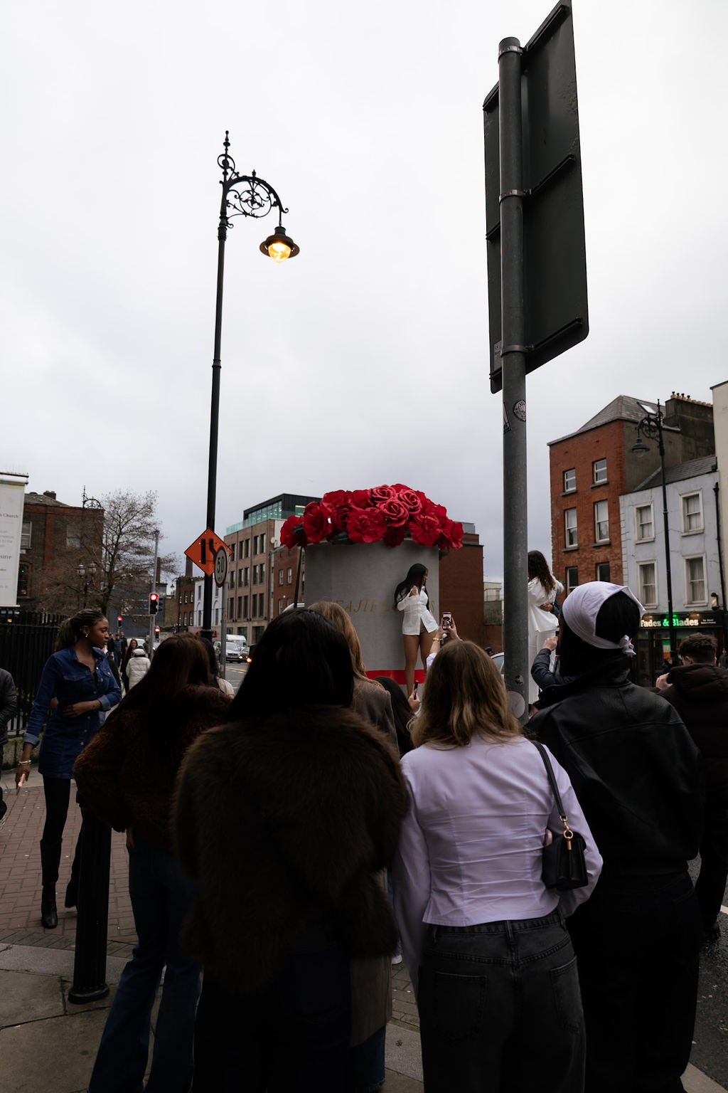 Visitors gathered around the oversized FajiFlowers rose-box display outside Ada Coffee.
